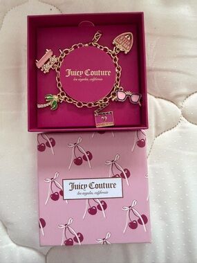 Juicy Couture Gold Charm Bracelet with Pink Accents and Green Leaf Charm